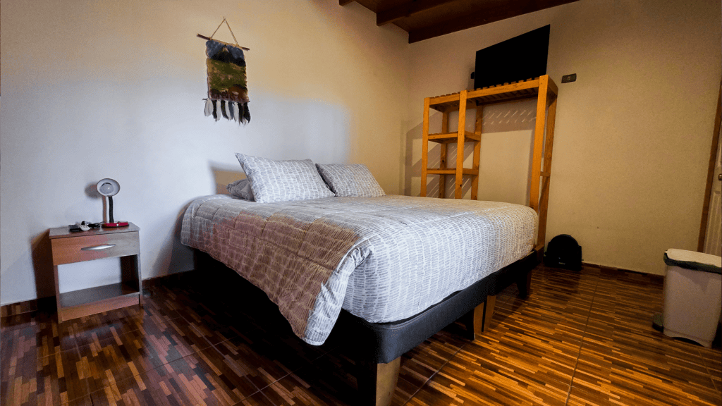 a bed with pillows and a shelf in a room