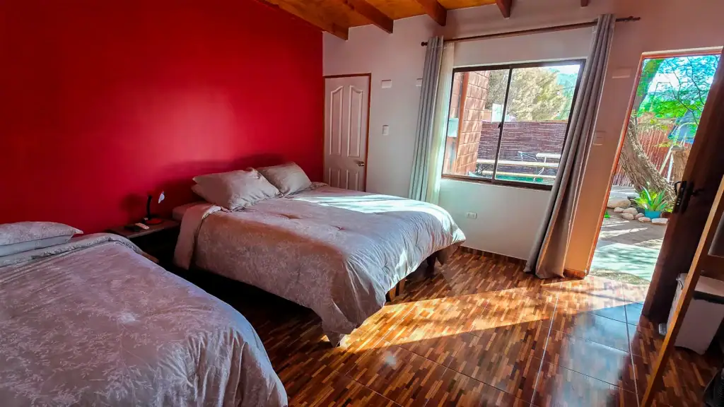 a bedroom with a wood floor and a window